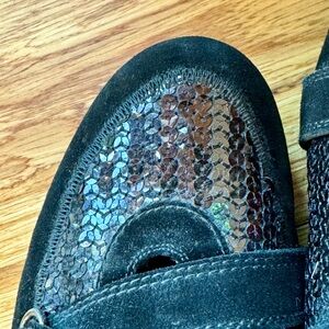 Stuart Weizmann embellished black sneakers with Rhine stones in the buckles